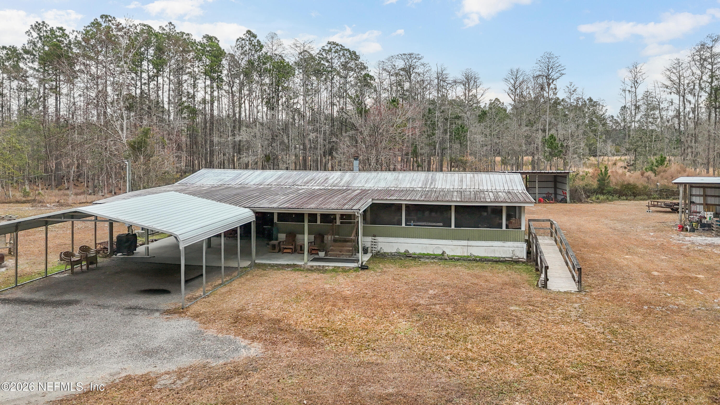 10697 County Road 127 Sanderson, FL 32087 - Photo 2 of 40 an outdoor view of a house with backyard space and balcony