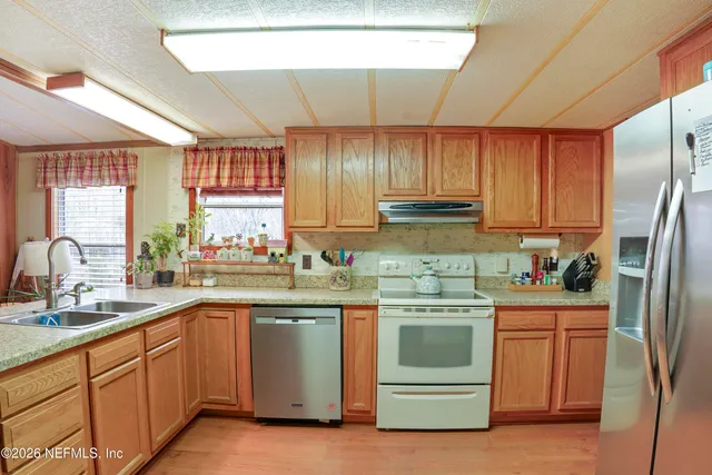 a kitchen with a sink stove and refrigerator