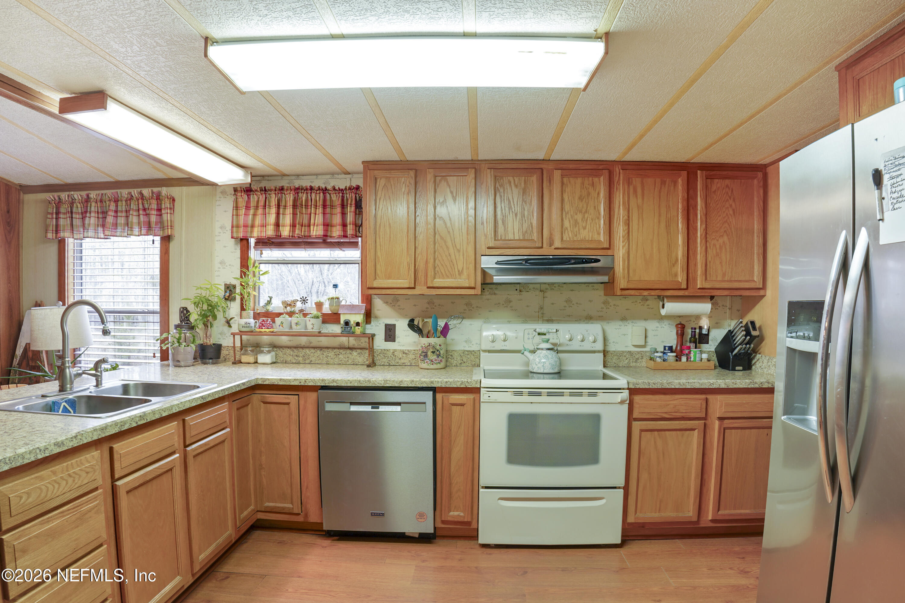 10697 County Road 127 Sanderson, FL 32087 - Photo 32 of 40 a kitchen with a sink stove and refrigerator