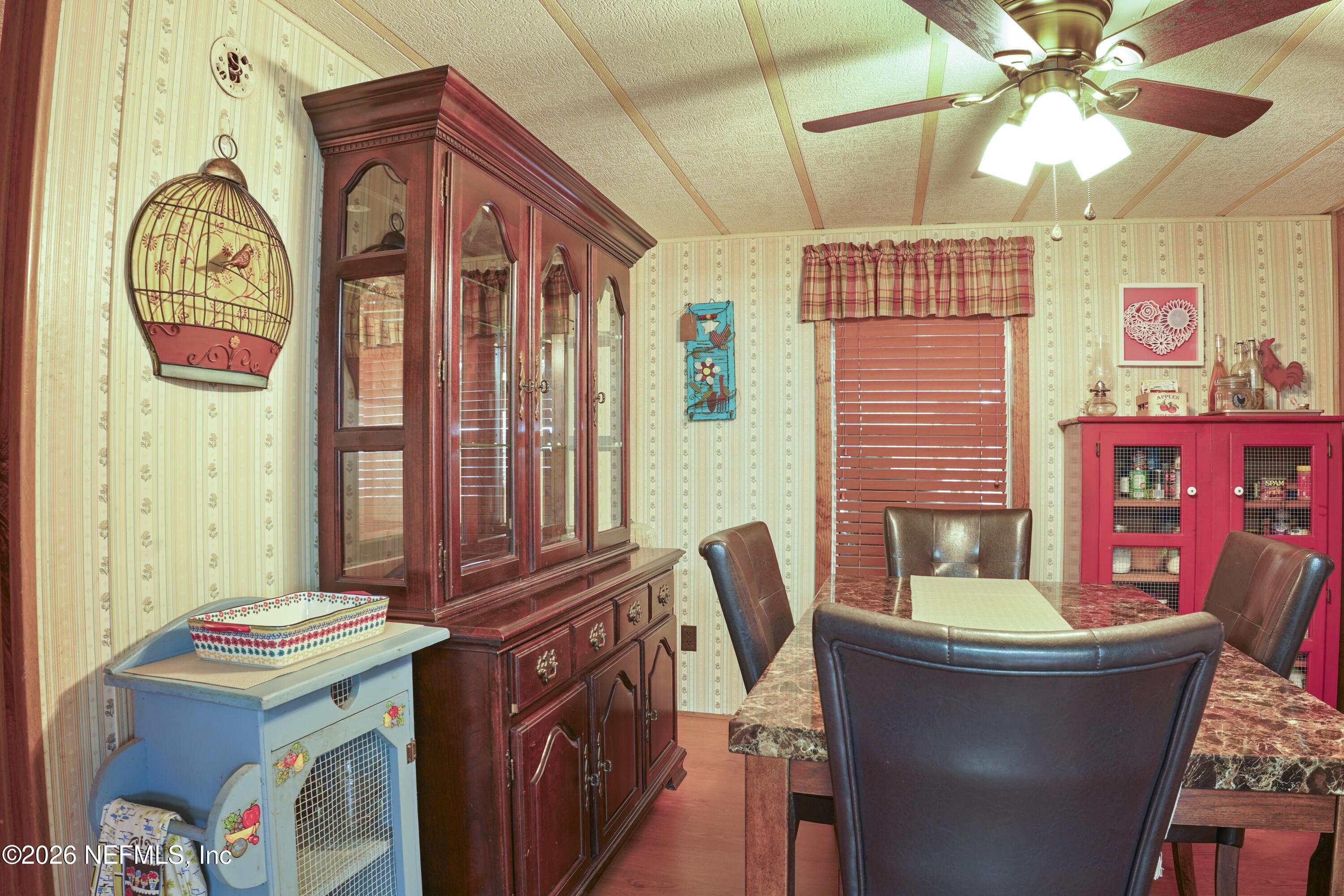 10697 County Road 127 Sanderson, FL 32087 - Photo 35 of 40 a bathroom with a sink a bathtub and a chandelier
