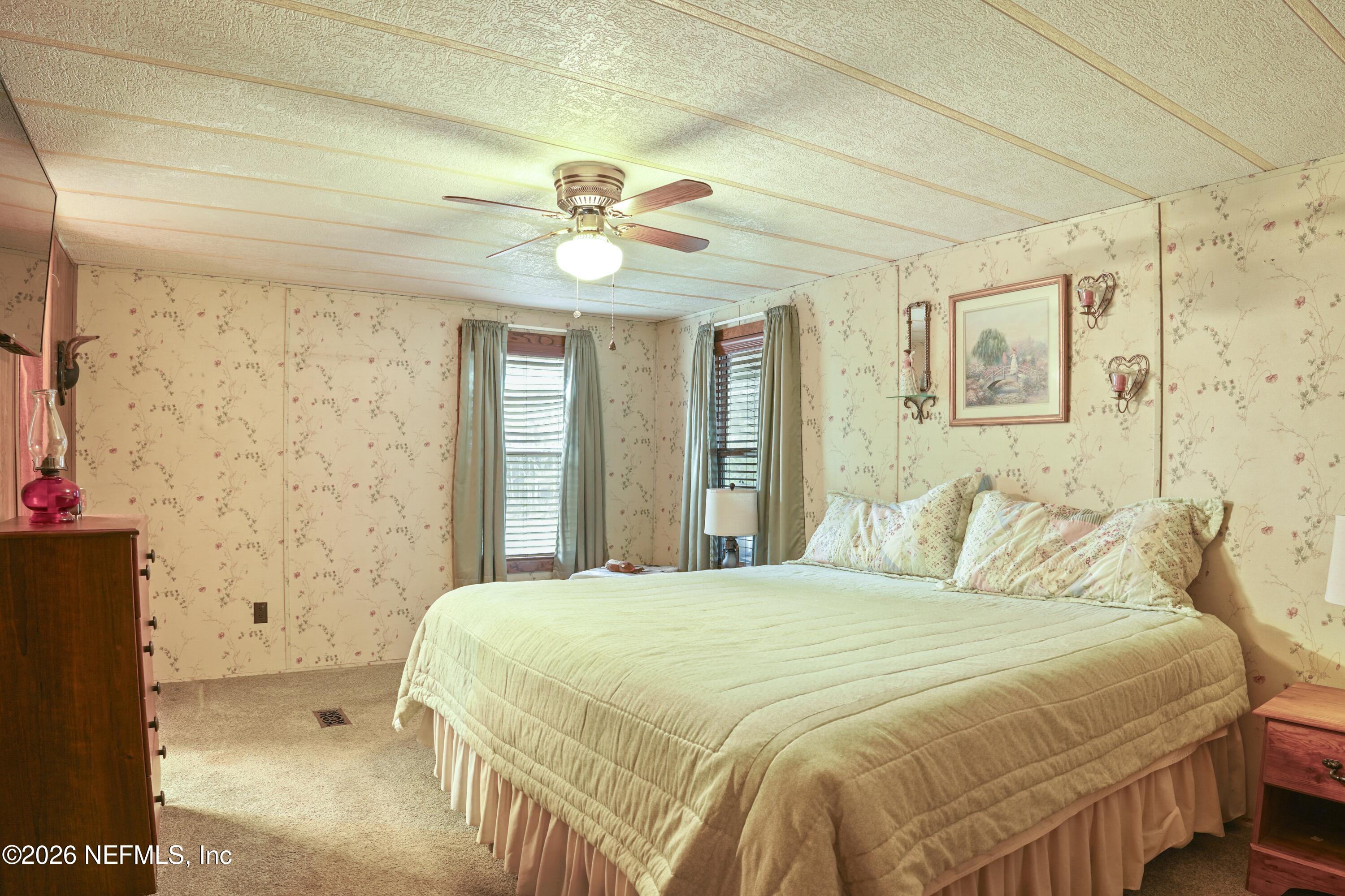 10697 County Road 127 Sanderson, FL 32087 - Photo 36 of 40 a bedroom with a bed and a chandelier