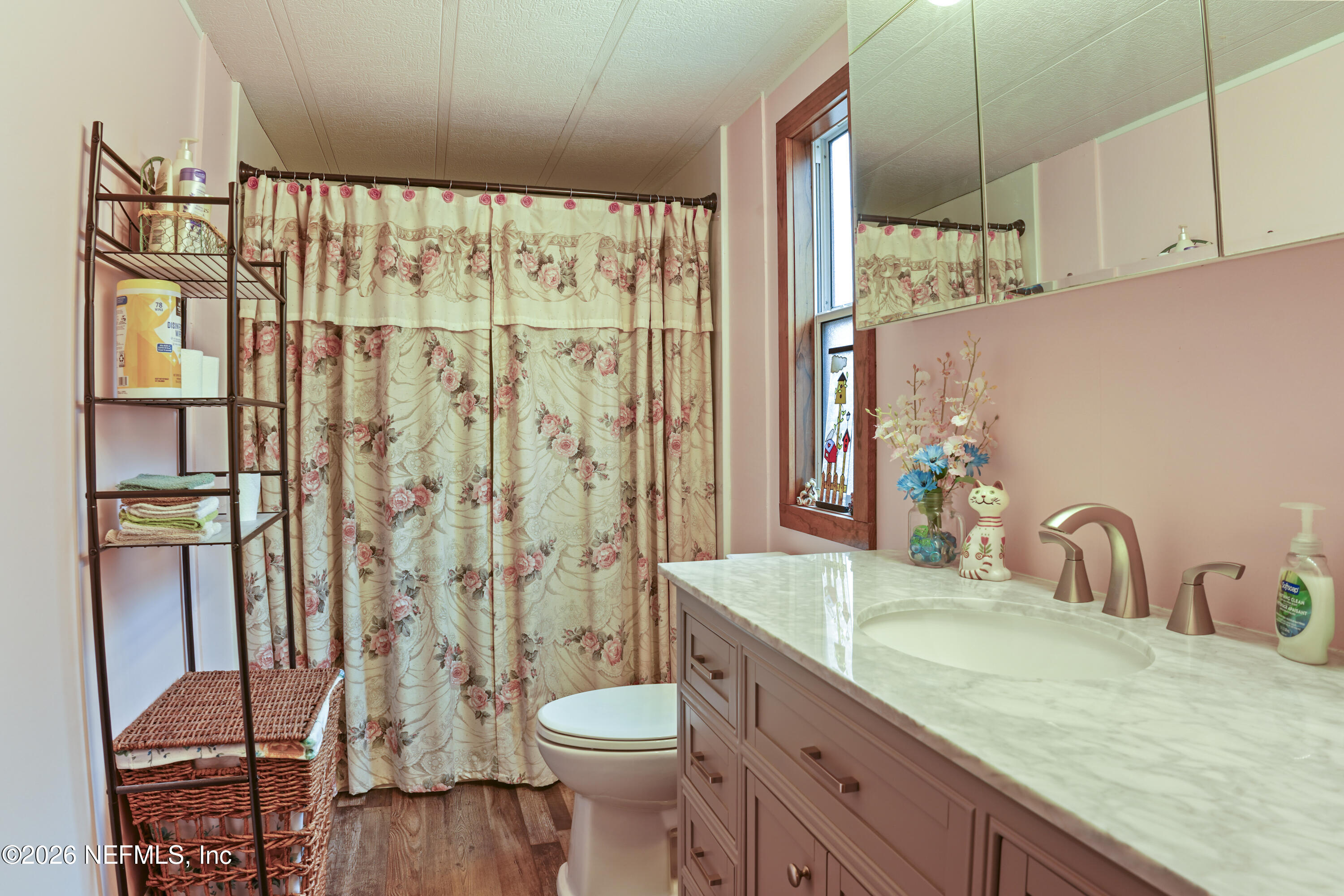 10697 County Road 127 Sanderson, FL 32087 - Photo 38 of 40 a bathroom with a granite countertop toilet sink and mirror