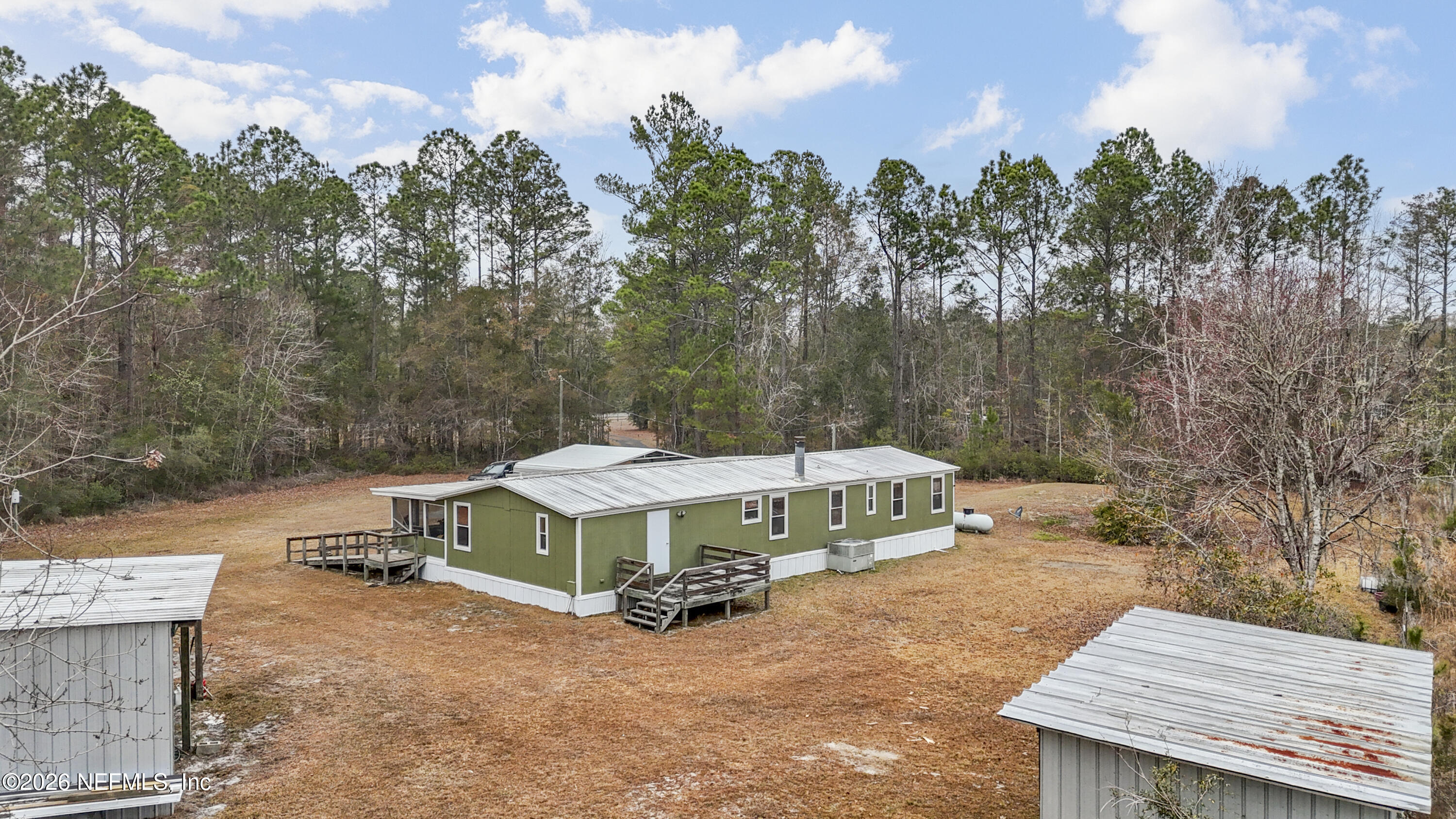 10697 County Road 127 Sanderson, FL 32087 - Photo 7 of 40 a view of a house with a yard and sitting area