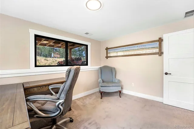 an aerial view of residential houses with outdoor space and trees all around