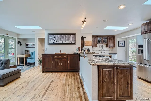 a kitchen with stove and wooden floor