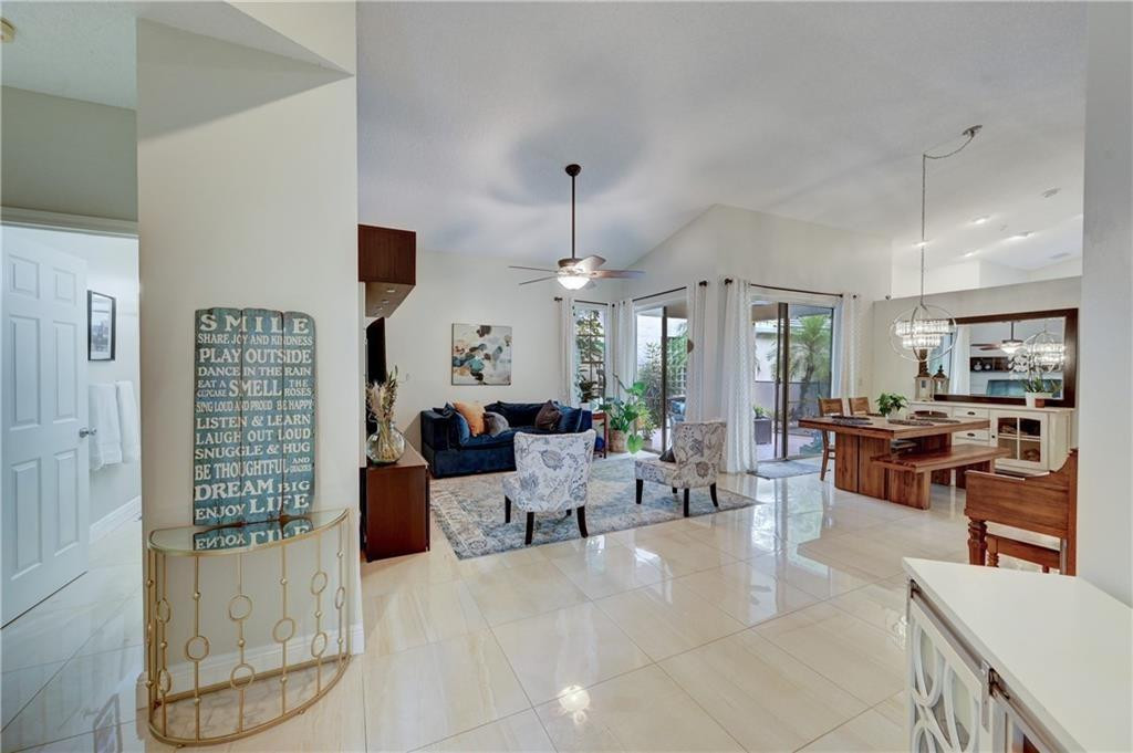 8171 Hampton Wood Drive Boca Raton, FL 33433 - Photo 5 of 56 a living room with furniture windows and a chandelier