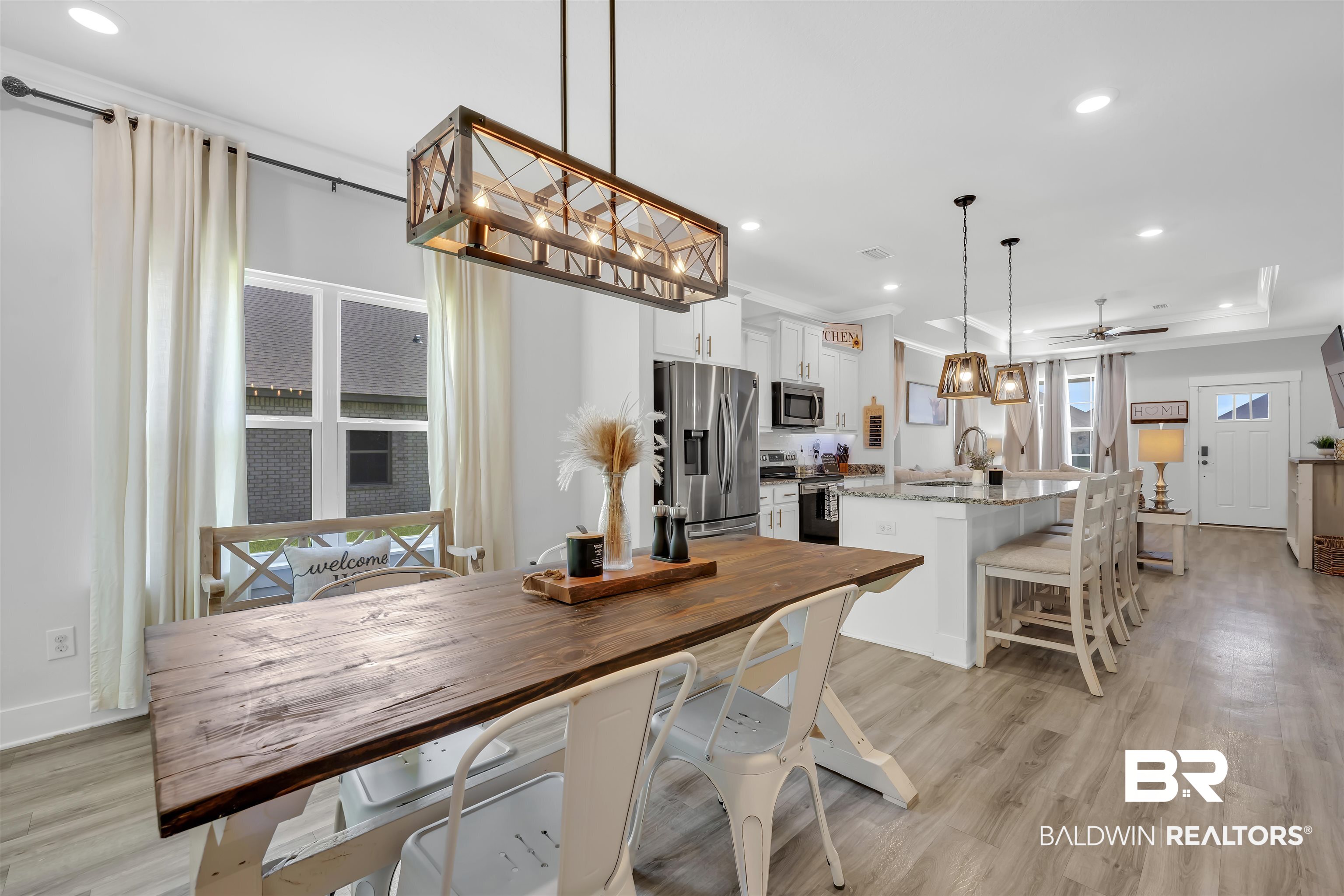 16504 Prado Loop Loxley, AL 36551 - Photo 17 of 45 Dining space with recessed lighting, a raised ceiling, ceiling fan, and light wood-style flooring