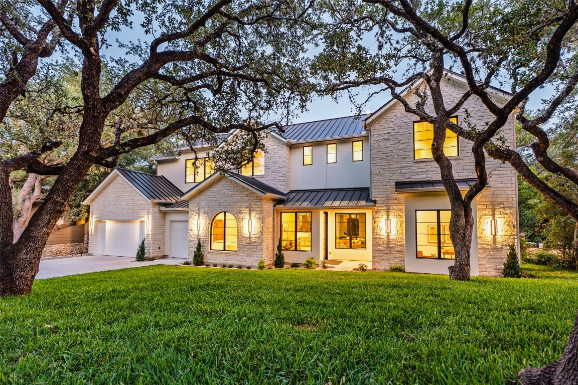 411 Honeycomb Ridge Austin, TX 78746 - Photo 1 of 1 a front view of a house with a garden