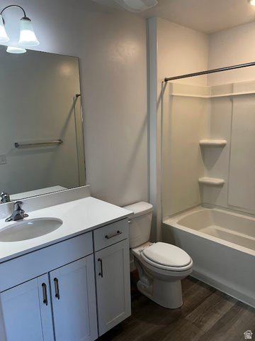 562 Hal Street, Unit 152 Tooele, UT 84074 - Photo 19 of 44 Full bathroom featuring a white vanity with integrated sink, a white countertop, and a built-in tub with shower