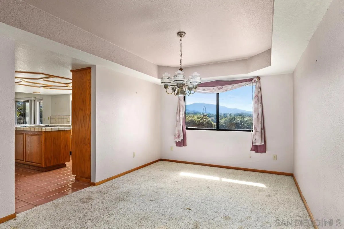 10099 El Capitan Real Road El Cajon, CA 92021 - Photo 11 of 41 a view of a hallway with a chandelier