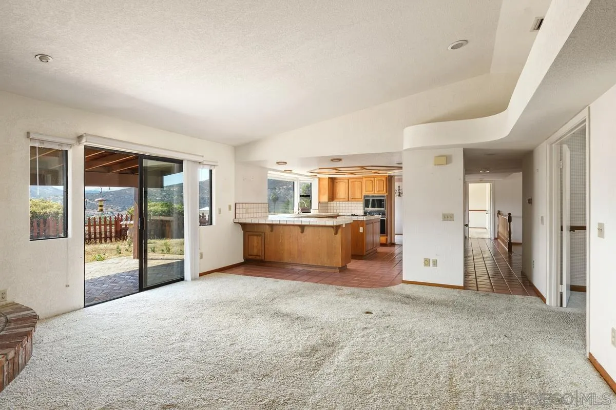 10099 El Capitan Real Road El Cajon, CA 92021 - Photo 13 of 41 a view of a kitchen with furniture and an empty room