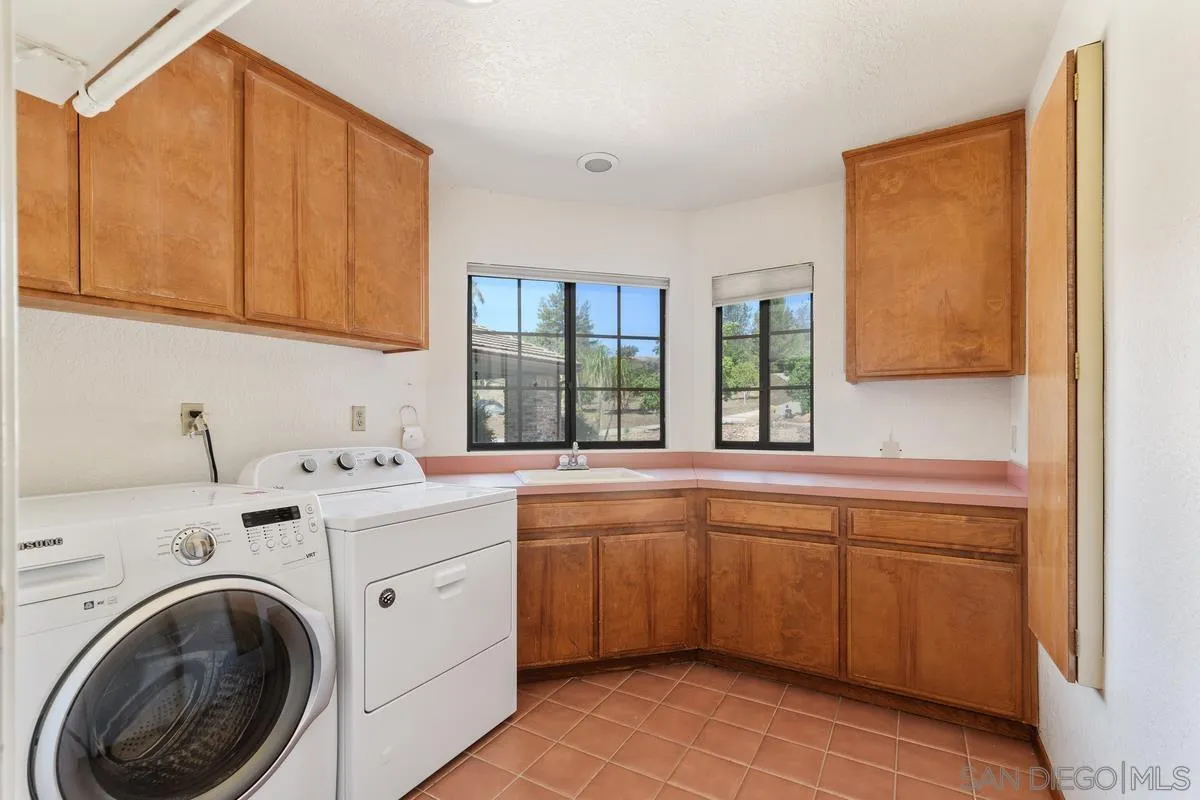 10099 El Capitan Real Road El Cajon, CA 92021 - Photo 22 of 41 a view of a kitchen with a sink cabinets and a window