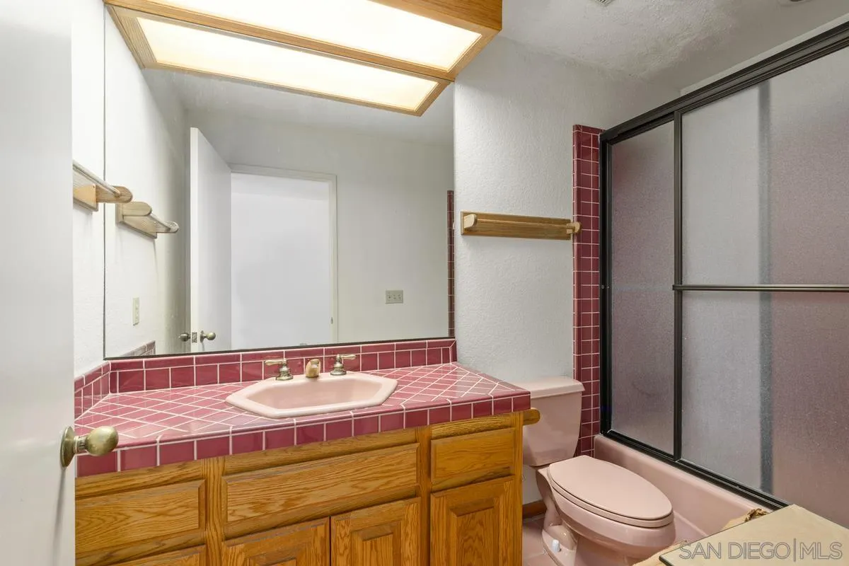 10099 El Capitan Real Road El Cajon, CA 92021 - Photo 23 of 41 a bathroom with a sink a toilet a mirror and shower