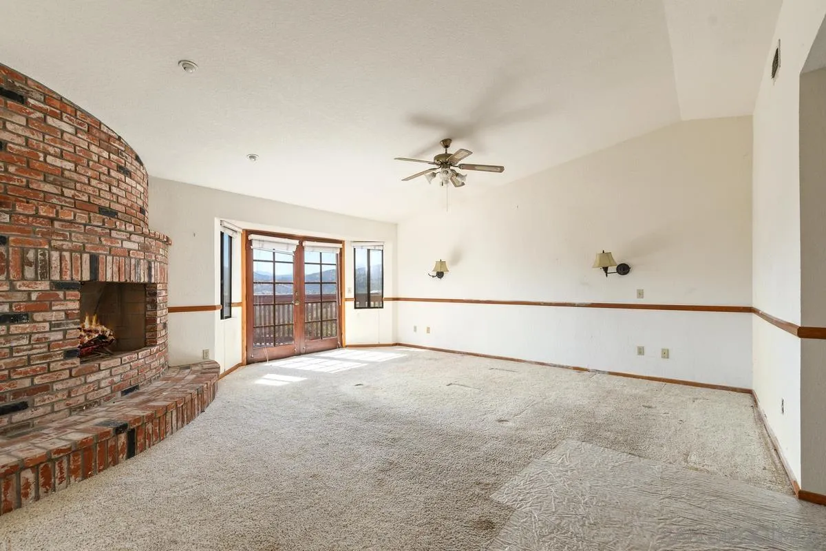 10099 El Capitan Real Road El Cajon, CA 92021 - Photo 24 of 41 a view of an empty room with a fireplace