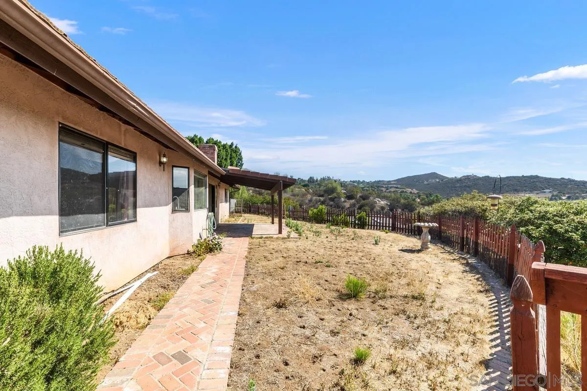 10099 El Capitan Real Road El Cajon, CA 92021 - Photo 31 of 41 a view of a house with a yard