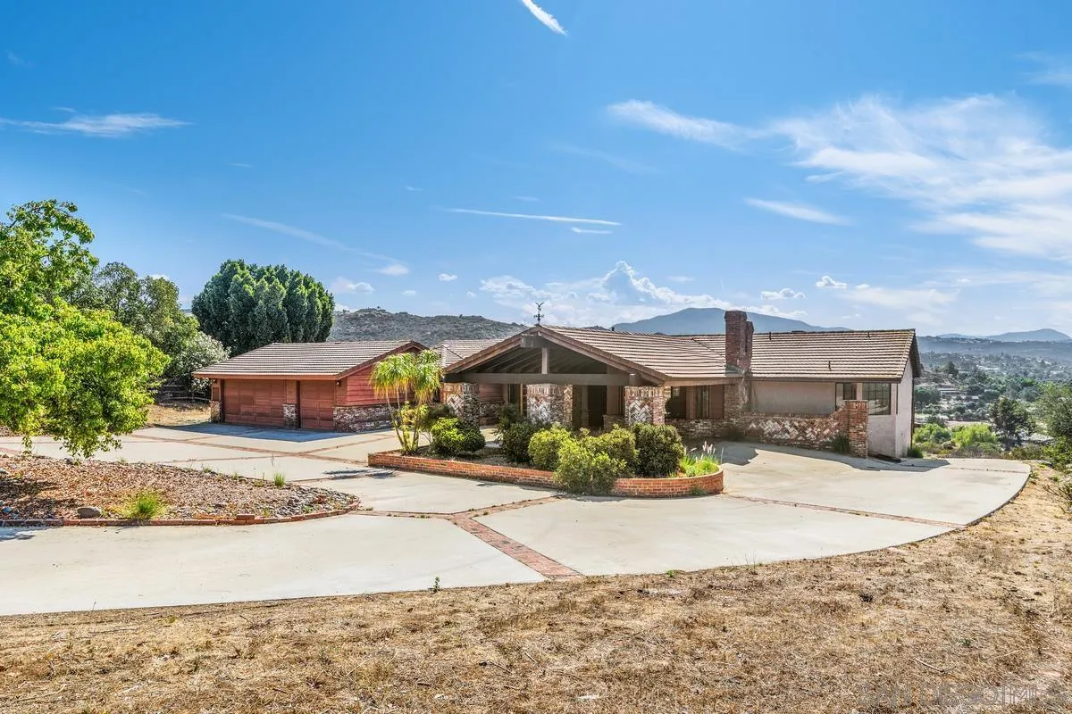 10099 El Capitan Real Road El Cajon, CA 92021 - Photo 4 of 41 a front view of a house with a yard