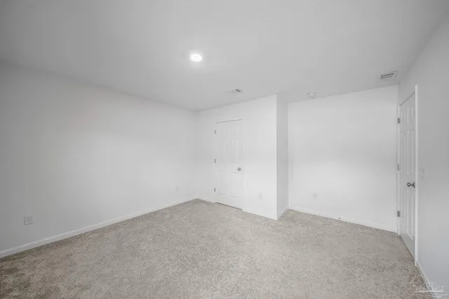 a view of an empty room and a window