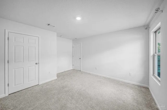 a kitchen with granite countertop a stove a sink and a refrigerator