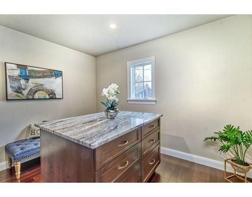 a bathroom with a granite countertop sink a mirror and vanity