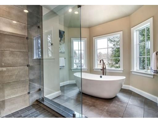 a spacious bathroom with a bathtub and shower