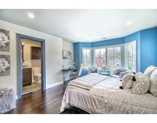 a bedroom with a large bed and a large window