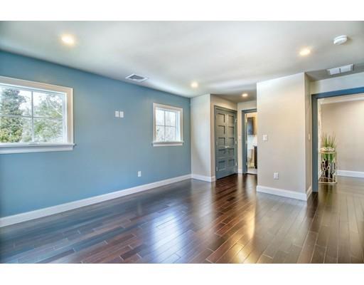 171 Pond Plain Road Westwood, MA 02090 - Photo 25 of 29 a view of an empty room with wooden floor and a window
