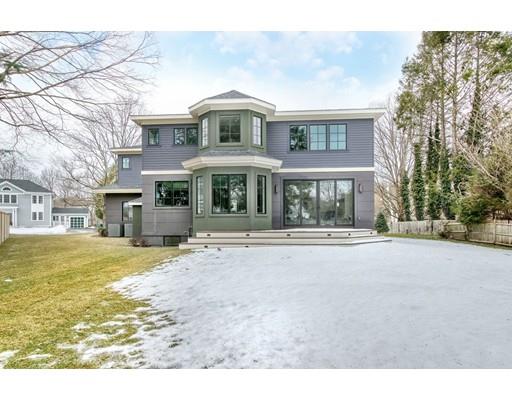171 Pond Plain Road Westwood, MA 02090 - Photo 28 of 29 a front view of a house with a yard and garage