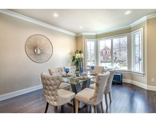 171 Pond Plain Road Westwood, MA 02090 - Photo 5 of 29 a dining room with wooden floor a chandelier a wooden table and chairs