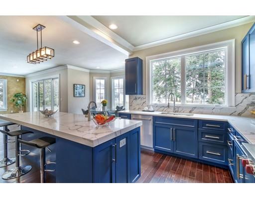 171 Pond Plain Road Westwood, MA 02090 - Photo 9 of 29 a kitchen with a wooden cabinets and center island