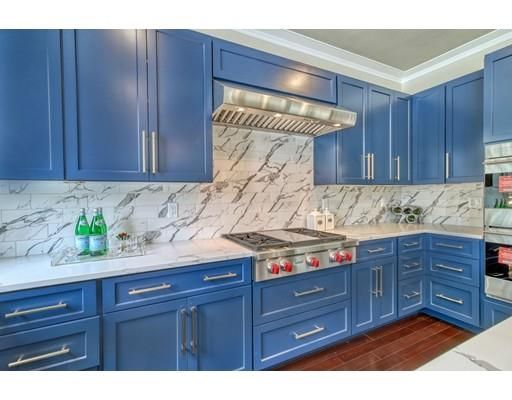 a kitchen with granite countertop wooden cabinets and wooden floor