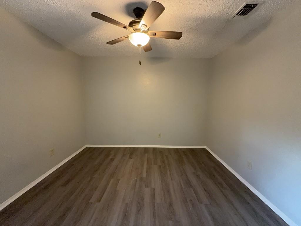 219 Fry Street, Unit 6 Denton, TX 76201 - Photo 8 of 13 wooden floor in a empty room