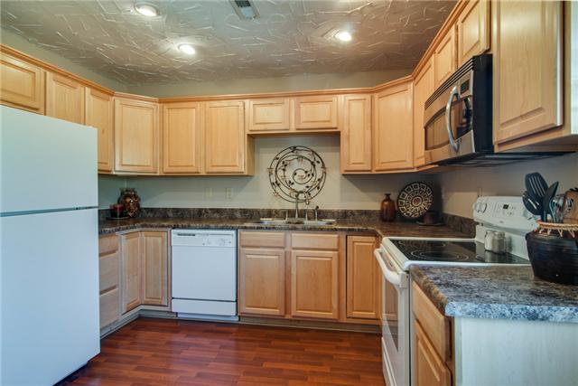 7194 Drag Strip Road Fairview, TN 37062 - Photo 11 of 20 a kitchen with stainless steel appliances granite countertop a sink stove and refrigerator