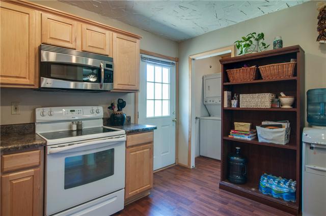 7194 Drag Strip Road Fairview, TN 37062 - Photo 12 of 20 a kitchen with stainless steel appliances a stove microwave and sink