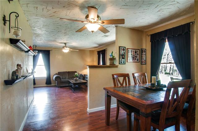 7194 Drag Strip Road Fairview, TN 37062 - Photo 13 of 20 a living room with couches a dining table and chairs with wooden floor