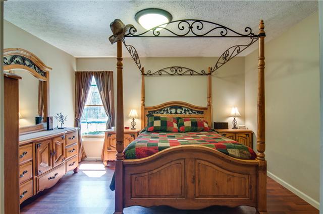 7194 Drag Strip Road Fairview, TN 37062 - Photo 15 of 20 a bedroom with a bed and a mirror on the dresser