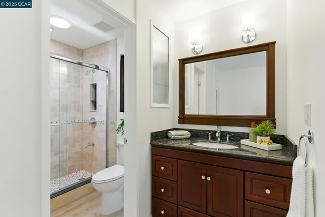 a bathroom with a shower a toilet and a sink