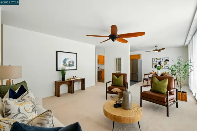 a dining room with furniture and a kitchen view