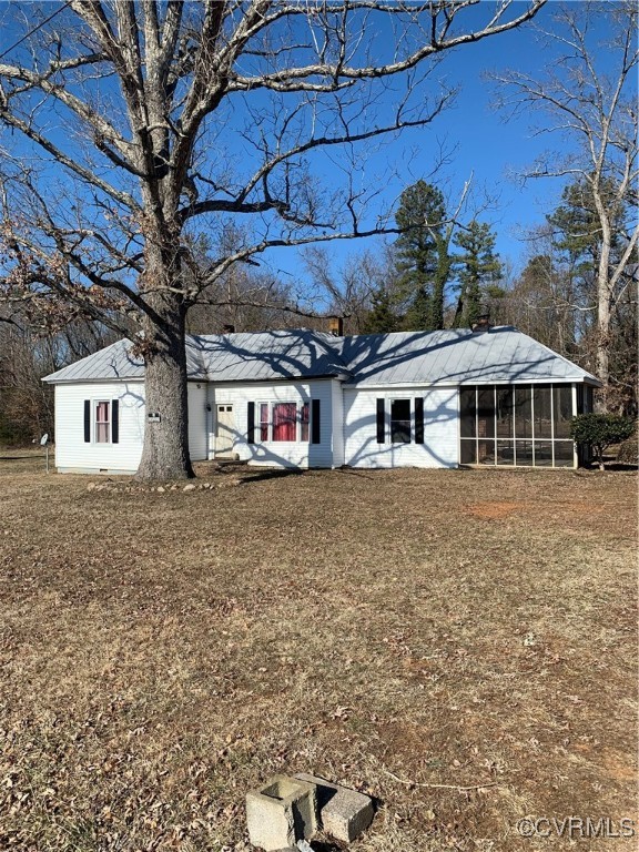 View of front of house featuring a sunroom and a f