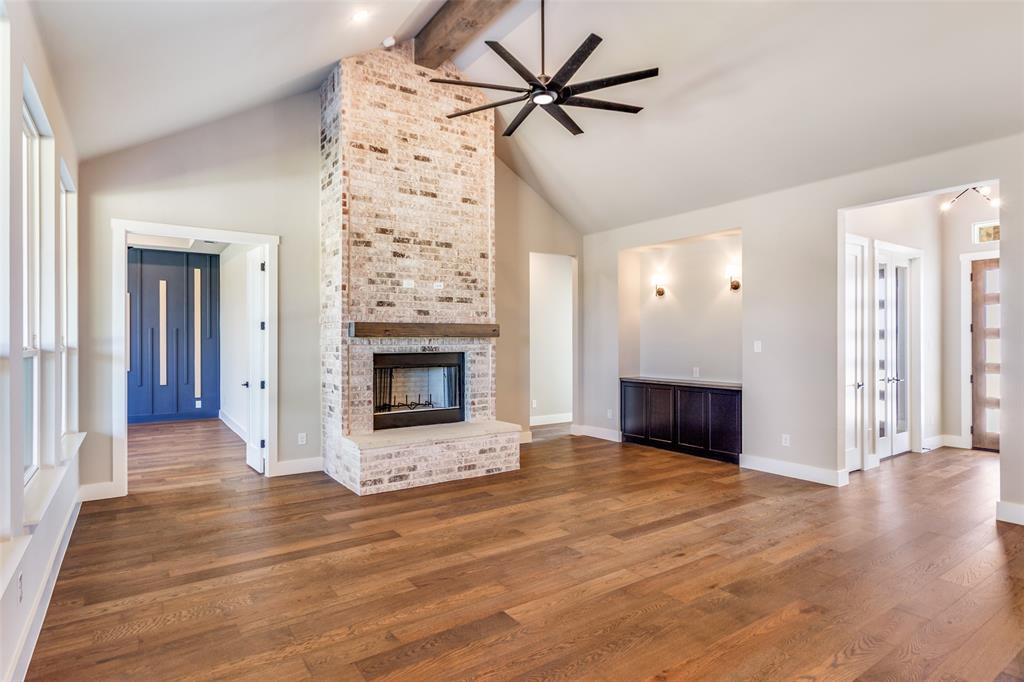 555 Aermotor Loop Weatherford, TX 76085 - Photo 8 of 30 a view of an empty room with a fireplace and a window