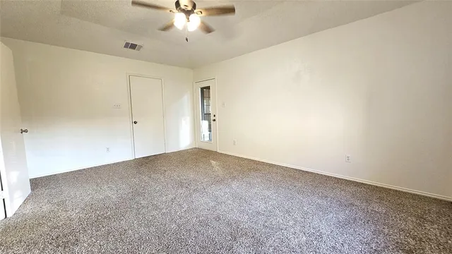 an empty room with a empty space and a ceiling fan