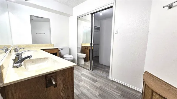 a kitchen with a sink a stove and wooden floor