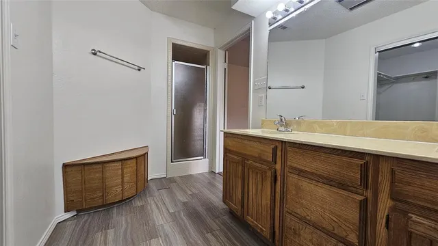 a room with wooden floor and cabinets