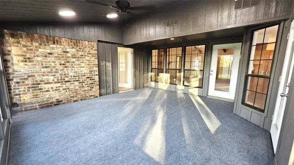 a view of an empty room with large windows