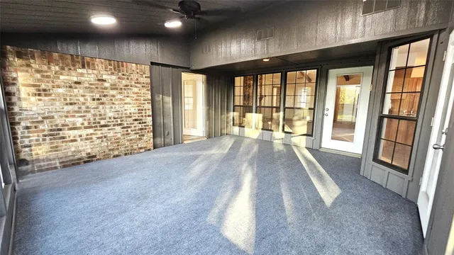 a view of an empty room with large windows