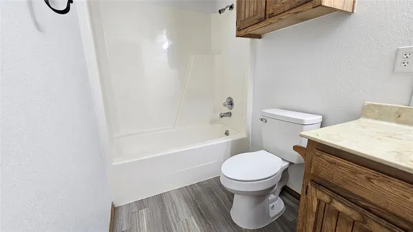a bathroom with a toilet sink vanity and mirror