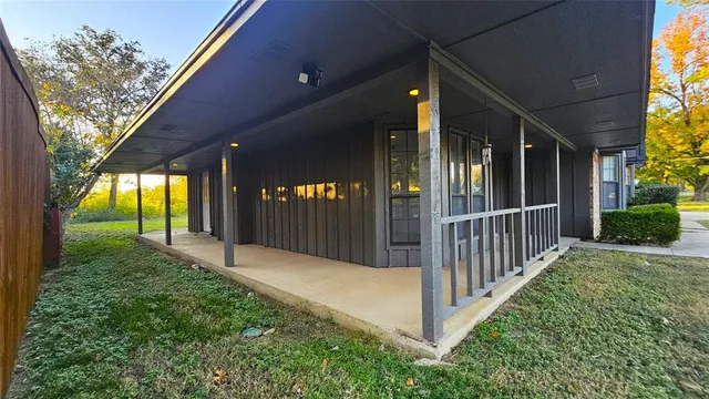 a view of a porch with a table and chairs and potted plants