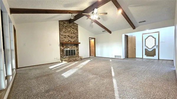 a view of a livingroom with entryway and window