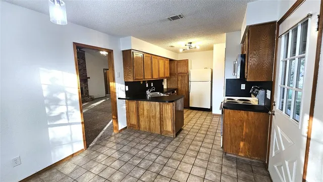 a kitchen with stainless steel appliances a refrigerator and a stove