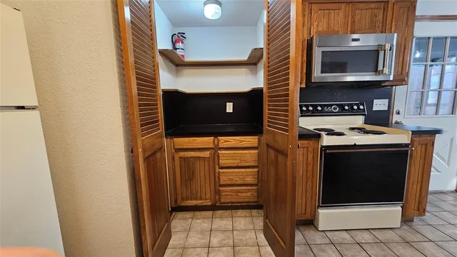 a kitchen with stainless steel appliances a stove and a microwave