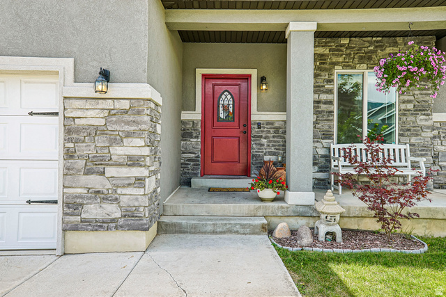 203 North 1900th Street West Mapleton, UT 84664 - Photo 2 of 48 Stone facade entry with a prominent red door featuring arched glass detailing